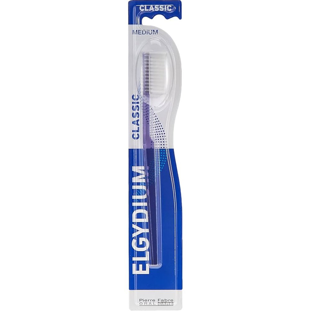 Elgydium Classic Medium Toothbrush Χειροκίνητη Οδοντόβουρτσα Ενηλίκων Μέτριας Σκληρότητας με Εργονομική Λαβή & Αποστρογγυλεμένες Ίνες 1 Τεμάχιο – Μωβ